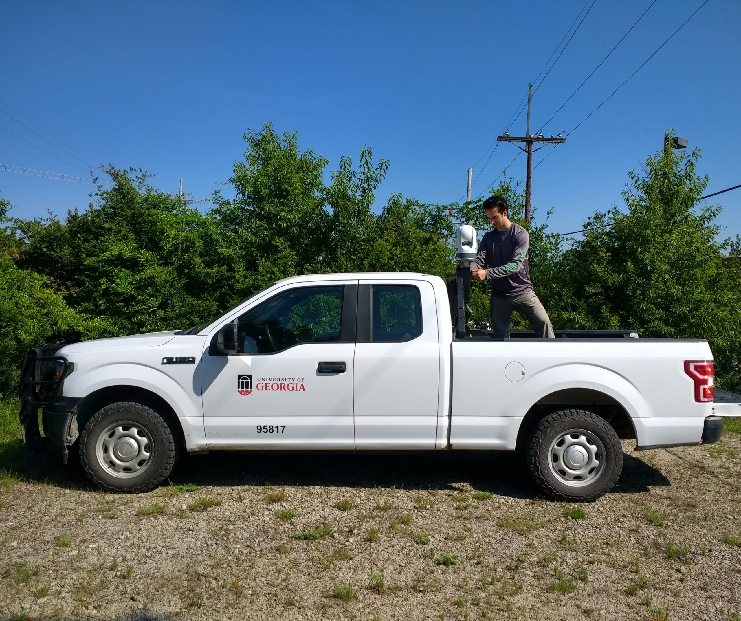 Carson is seen setting up an infrared camera on a field vehicle. (Photo courtesy of Carson Pakula)